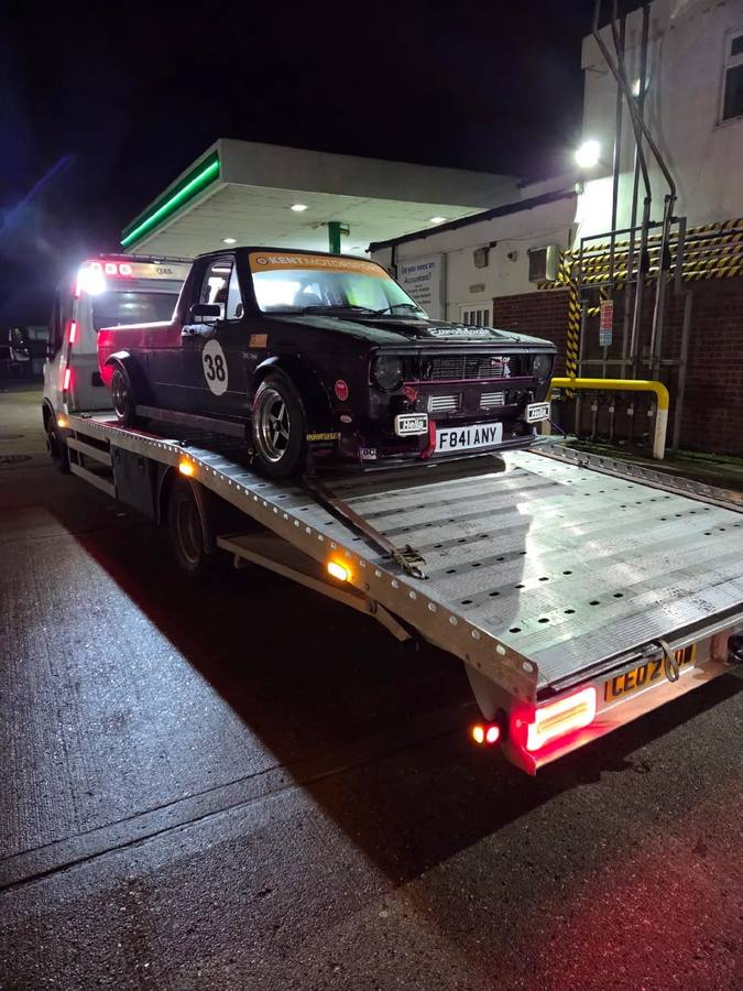 Dark purple custom race car transported on recovery truck
